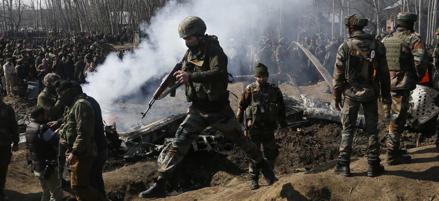In this Wednesday, Feb.27, 2019 file photo, Indian army soldiers arrive at the wreckage of an Indian helicopter after it crashed killing several in the Budgam area, on the outskirts of Srinagar, Indian controlled Kashmir.