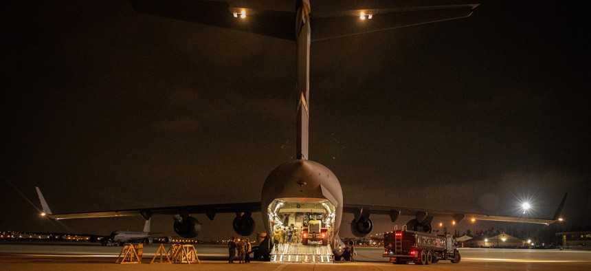 Personnel load a Marine Corps 155 mm M777 towed howitzer into an Air Force C-17 Globemaster III at March Air Reserve Base, Calif., April 21, 2022.